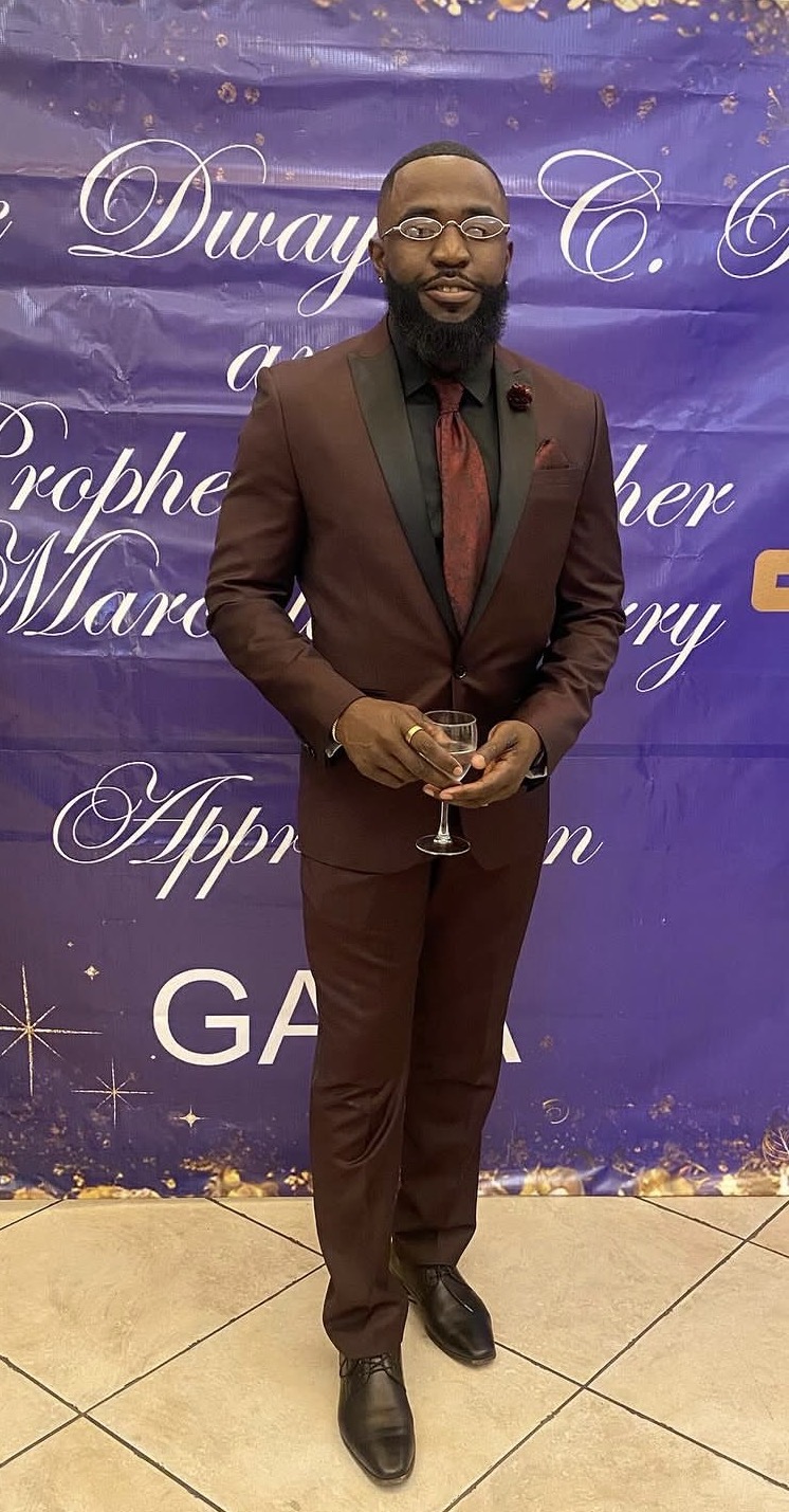 Brandon Braithwaite wearing a burgundy suit