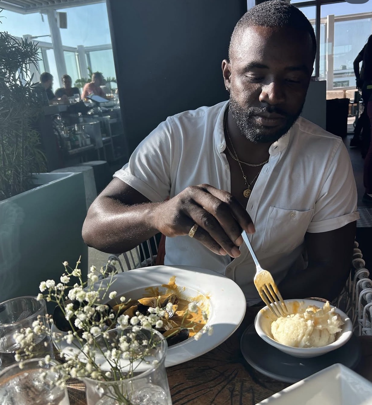 Brandon Braithwaite sharing a meal in a sunlit restaurant